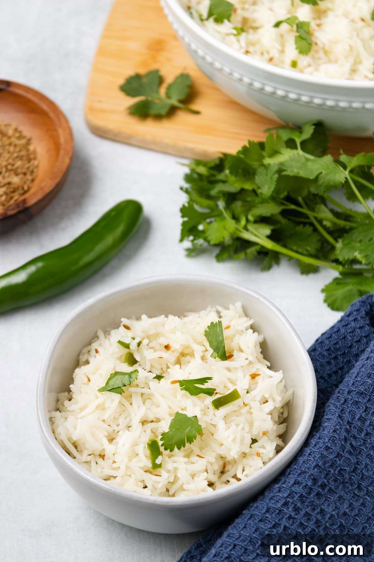 A close up image of quick jeera rice in a small bowl. 