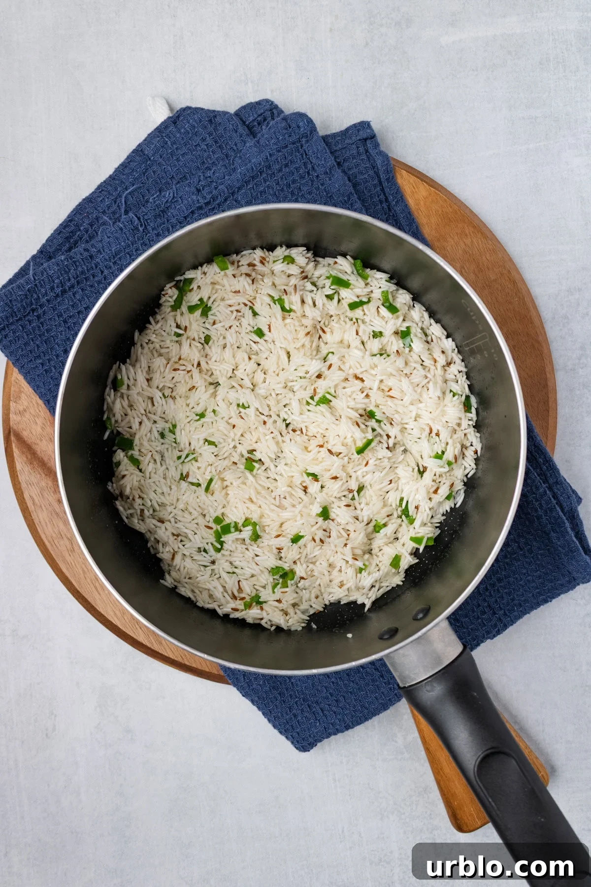 An overhead iamge of adding rice and coating it with the spices.