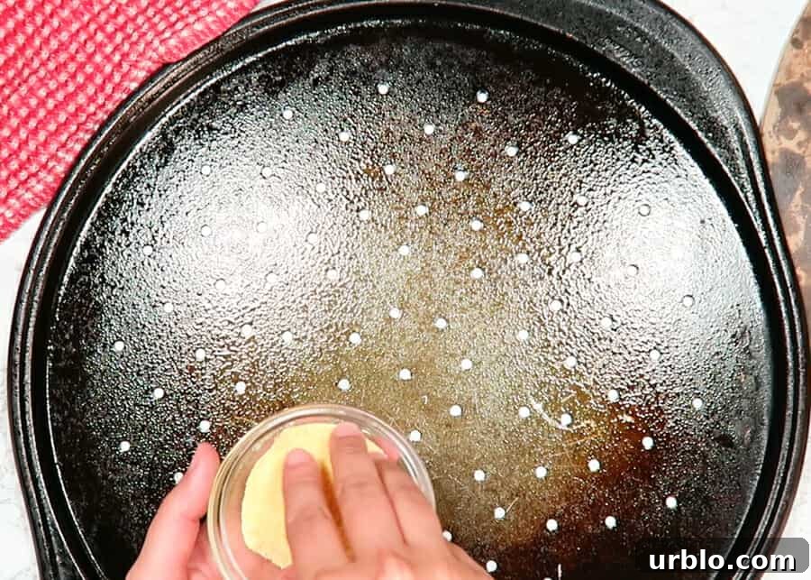 sprinkling corn meal on the pan to bake the thin crust pizza dough