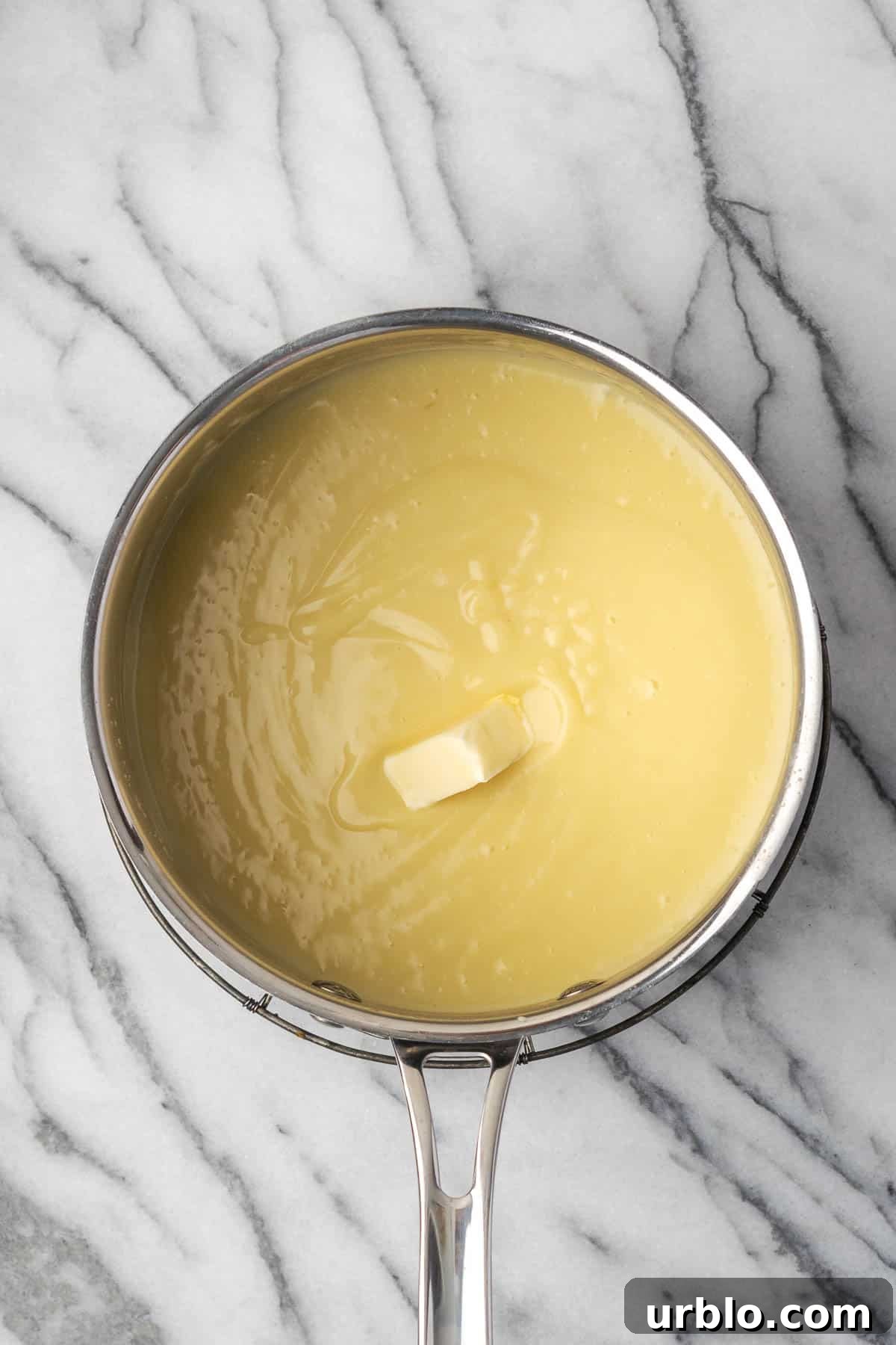 A pat of butter added to the saucepan with the cooked pudding. 