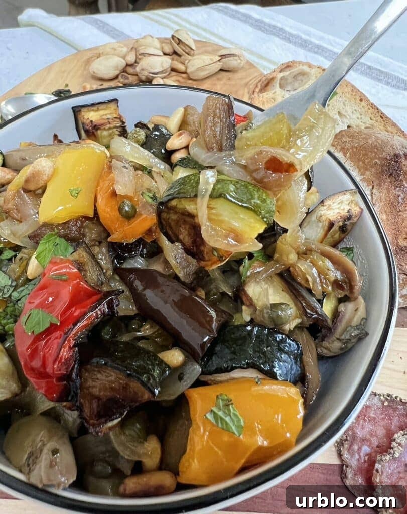 Bowl of vegetable caponata with fork.