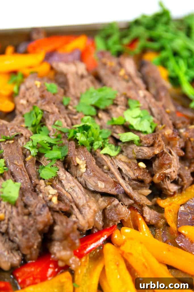 up close shot of cilantro lime sheet pan fajitas with cilantro on top