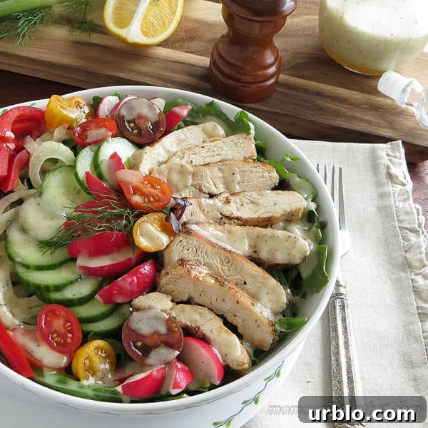 Grilled chicken salad with vegetables and dressing in a bowl with napkin
