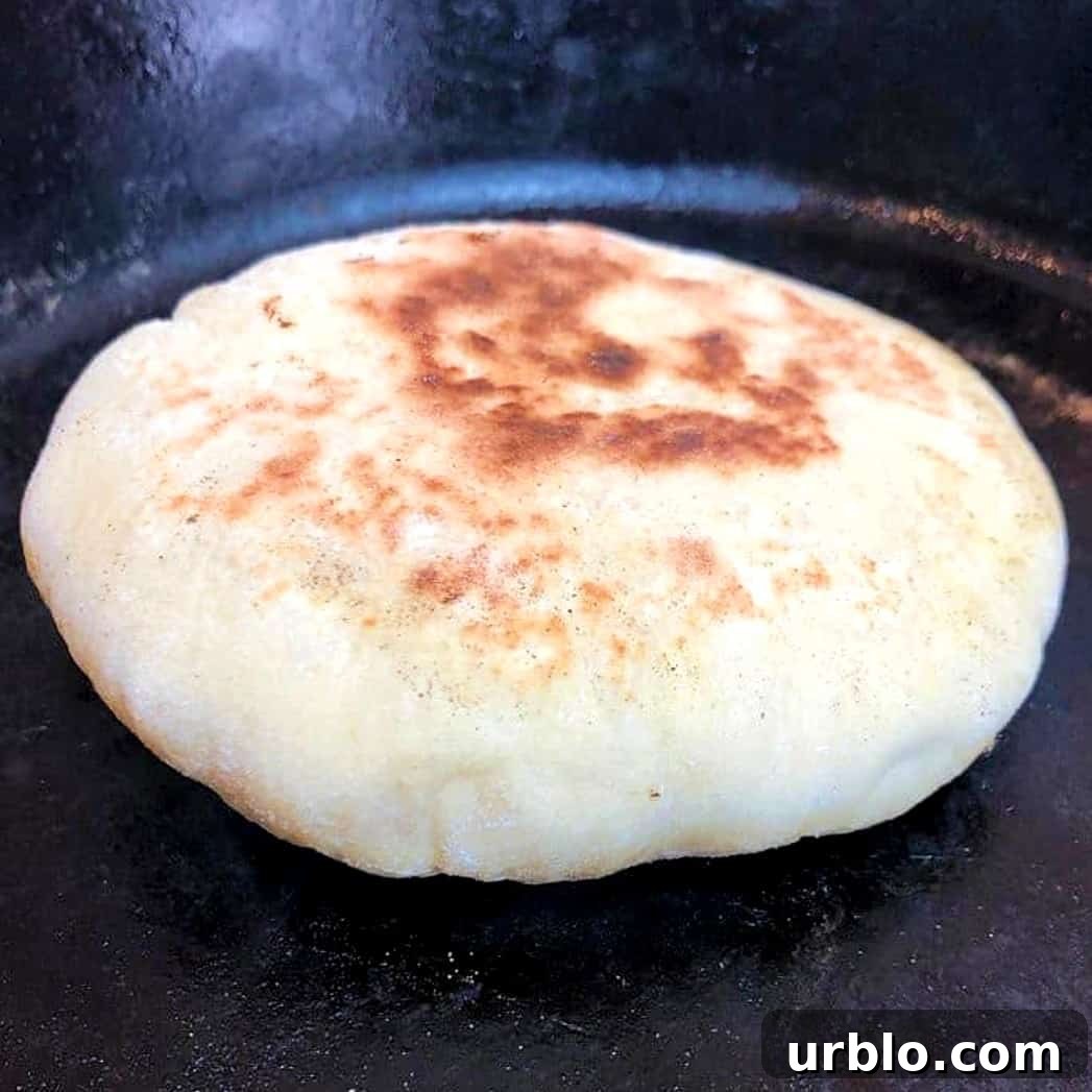 cooked pita on a hot pan.