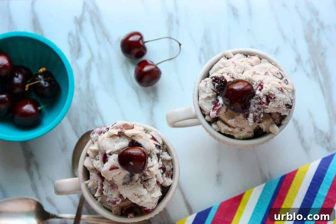 Homemade Cherry Amaretto Ice Cream Recipe 5 Two dishes of ice cream next to a bowl of cherries.
