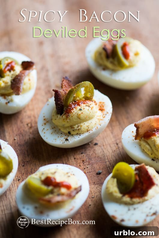 Deviled Eggs Recipe with Bacon, Sriracha, Jalapeño Spicy Deviled Eggs | @bestreciepbox Deviled Eggs Recipe with Bacon, Sriracha, Jalapeño Spicy Deviled Eggs on a cutting board