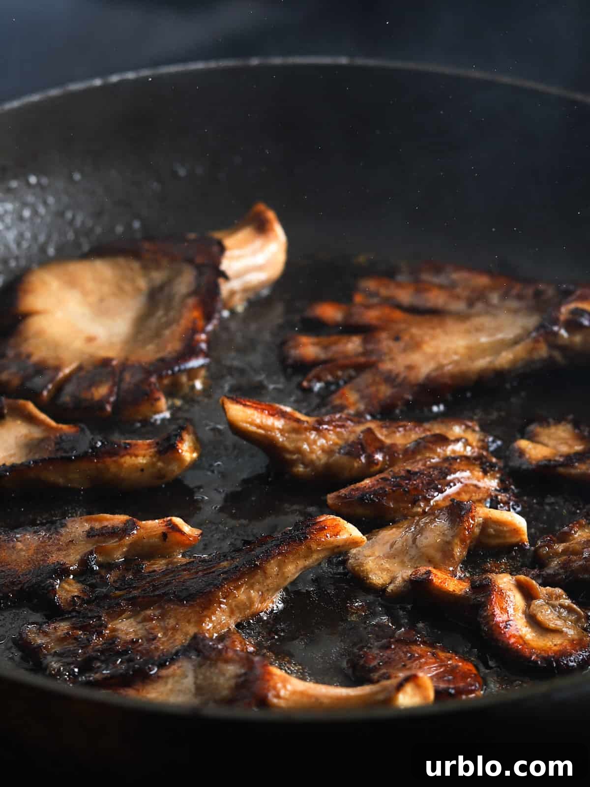 Photo showing vegan Char Siu mushrooms frying in a pan.