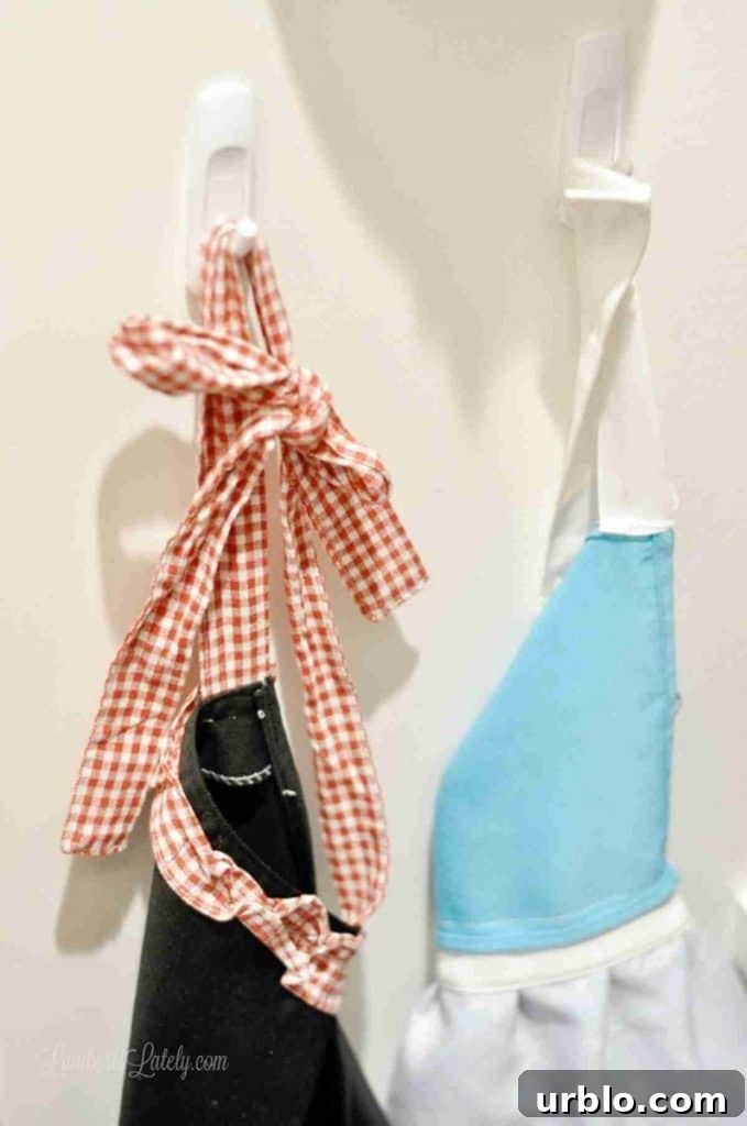 plastic pegs holding cooking aprons.