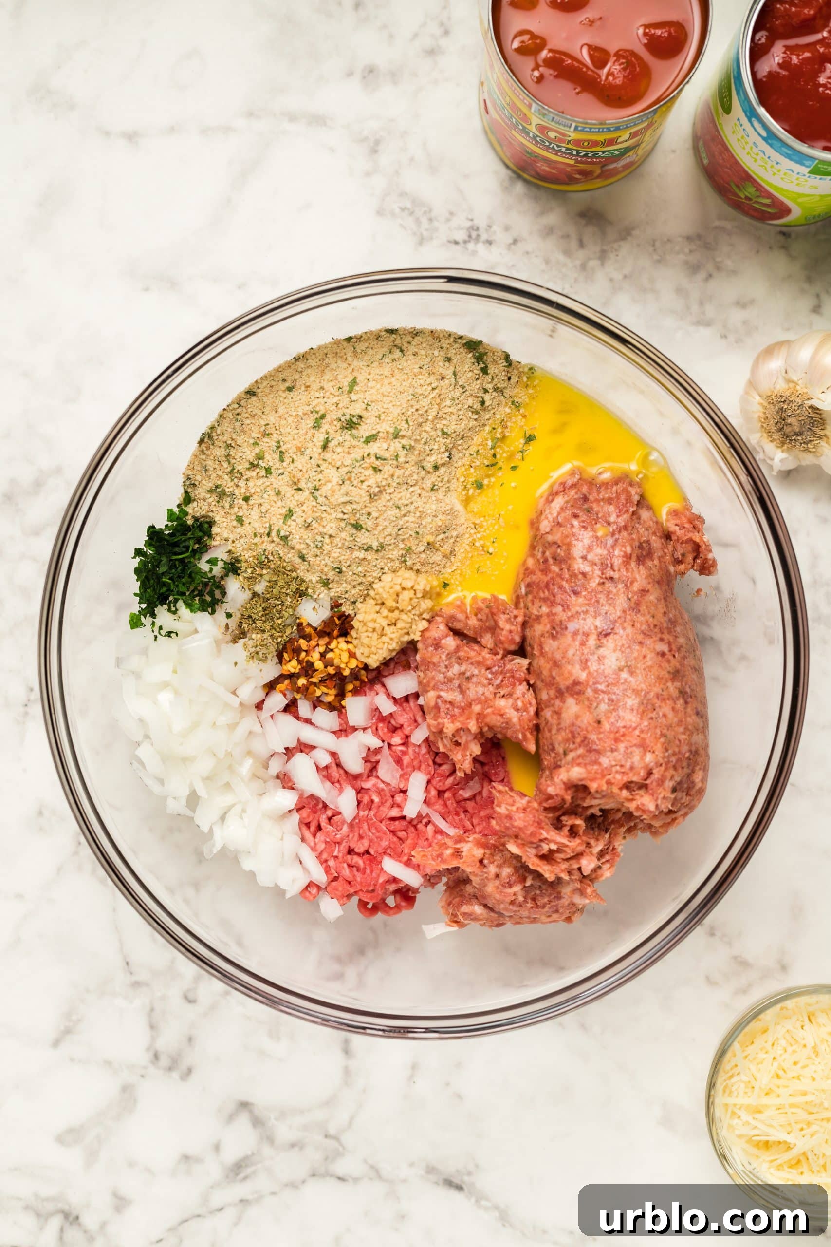 Ingredients for easy meatball subs in a bowl on a marble countertop.