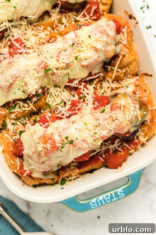 A baked meatball sandwich filled with sauce and cheese.