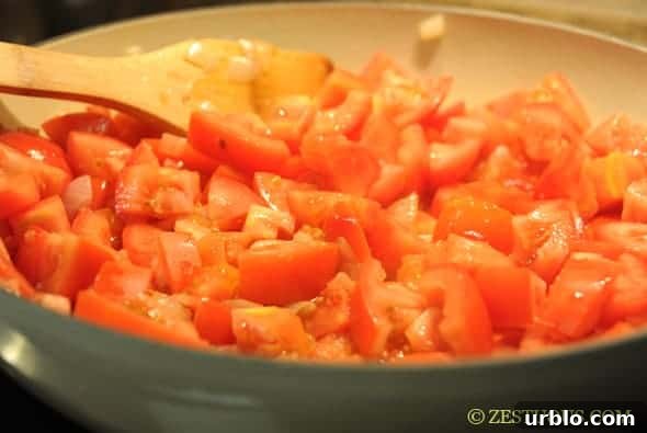 tomatoes simmering in a pan
