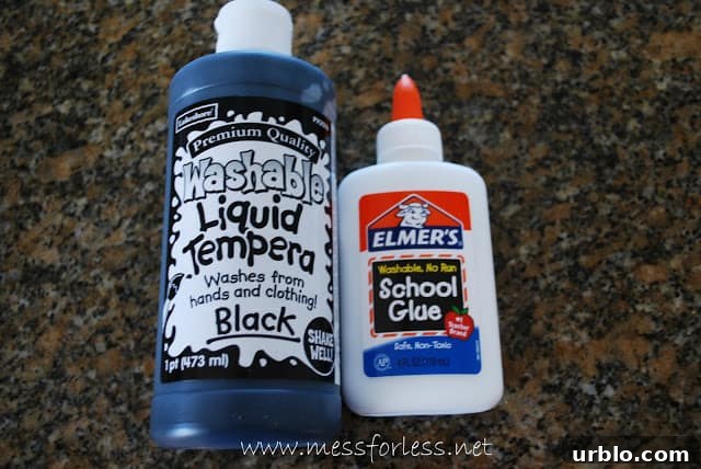 bottle on white glue and bottle of black tempera paint