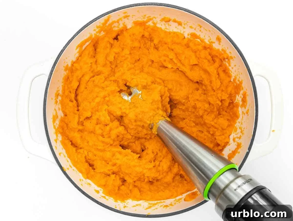 blending sweet potatoes with immersion blender