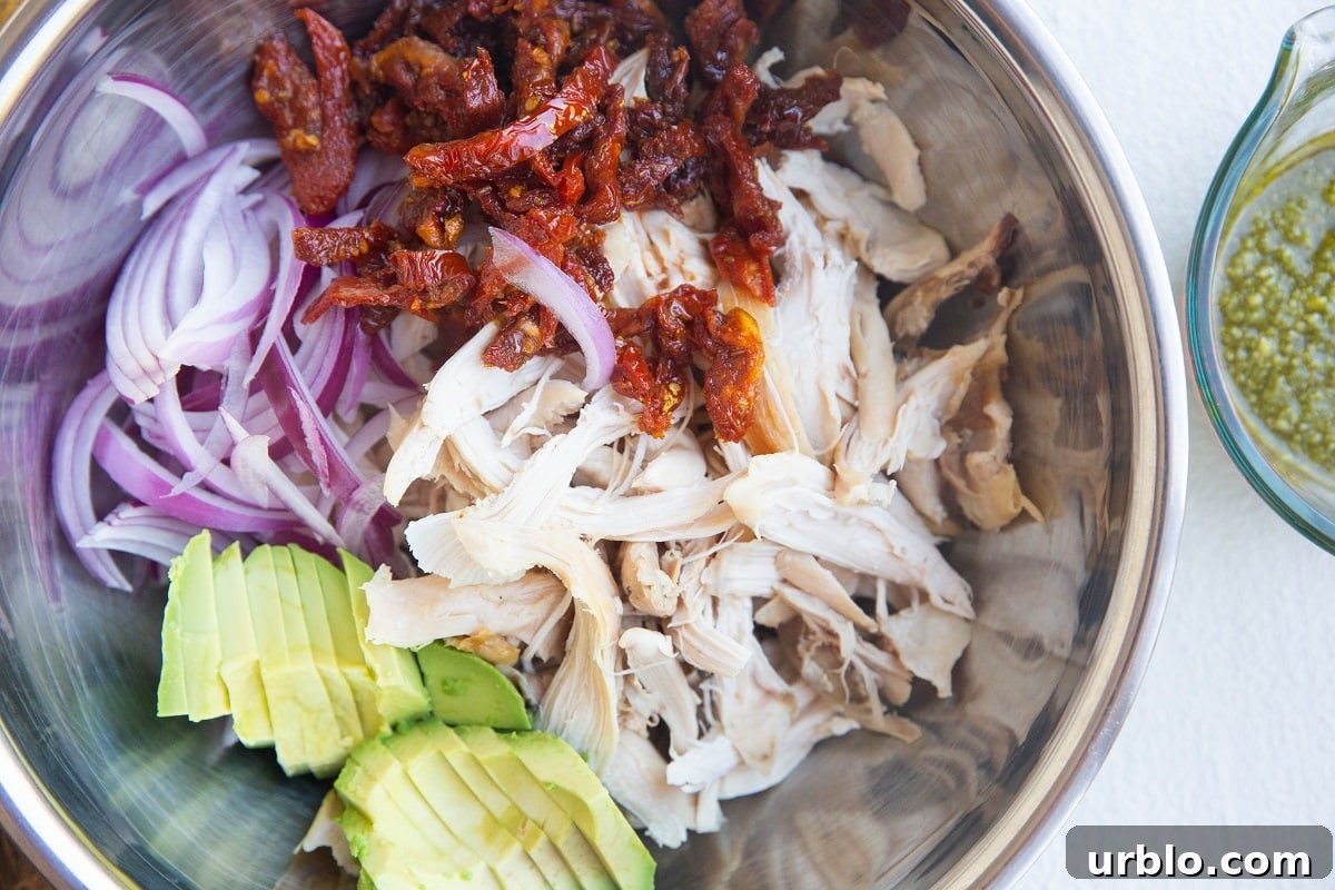 Ingredients for chicken salad in a mixing bowl