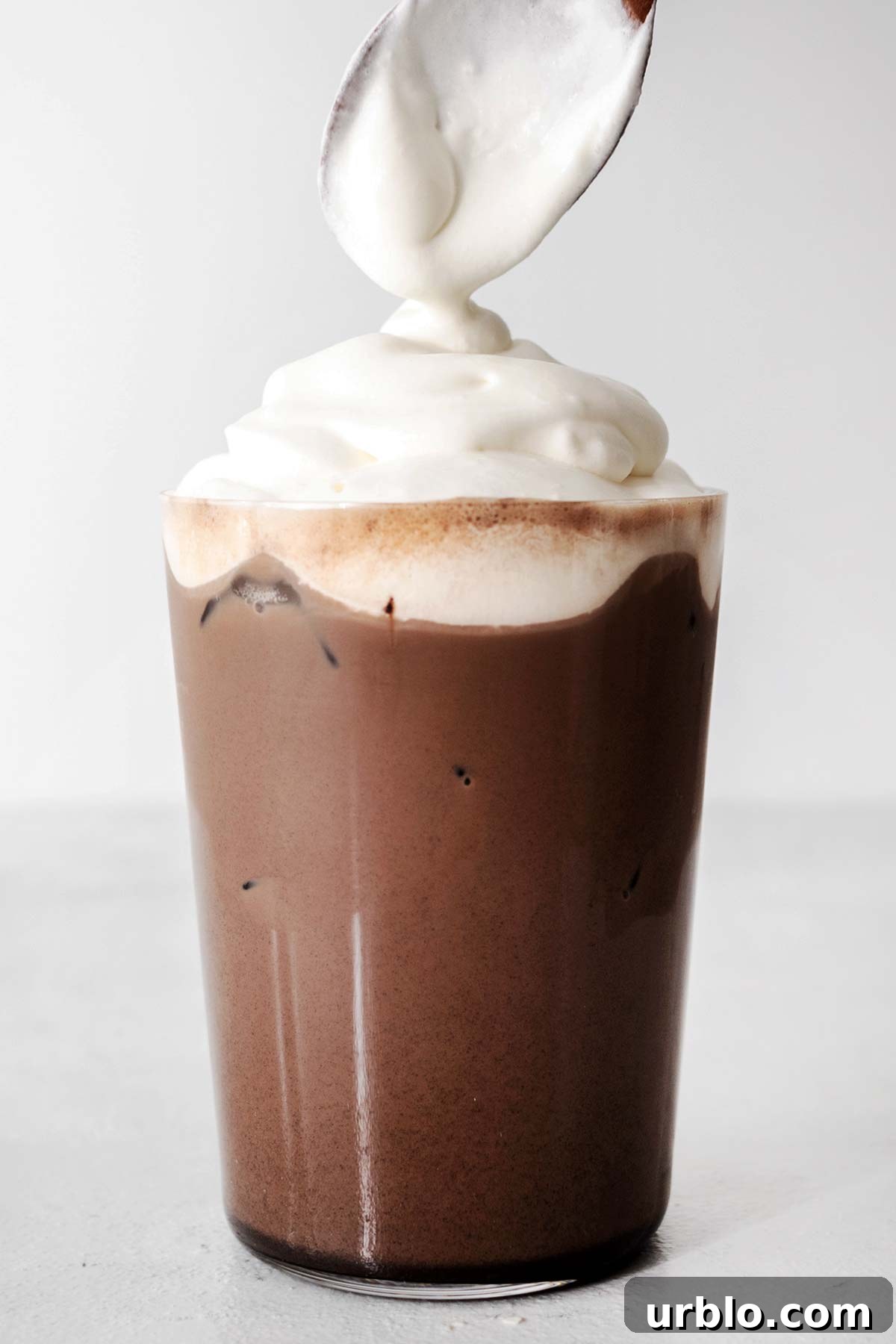 Topping with whipped cream.