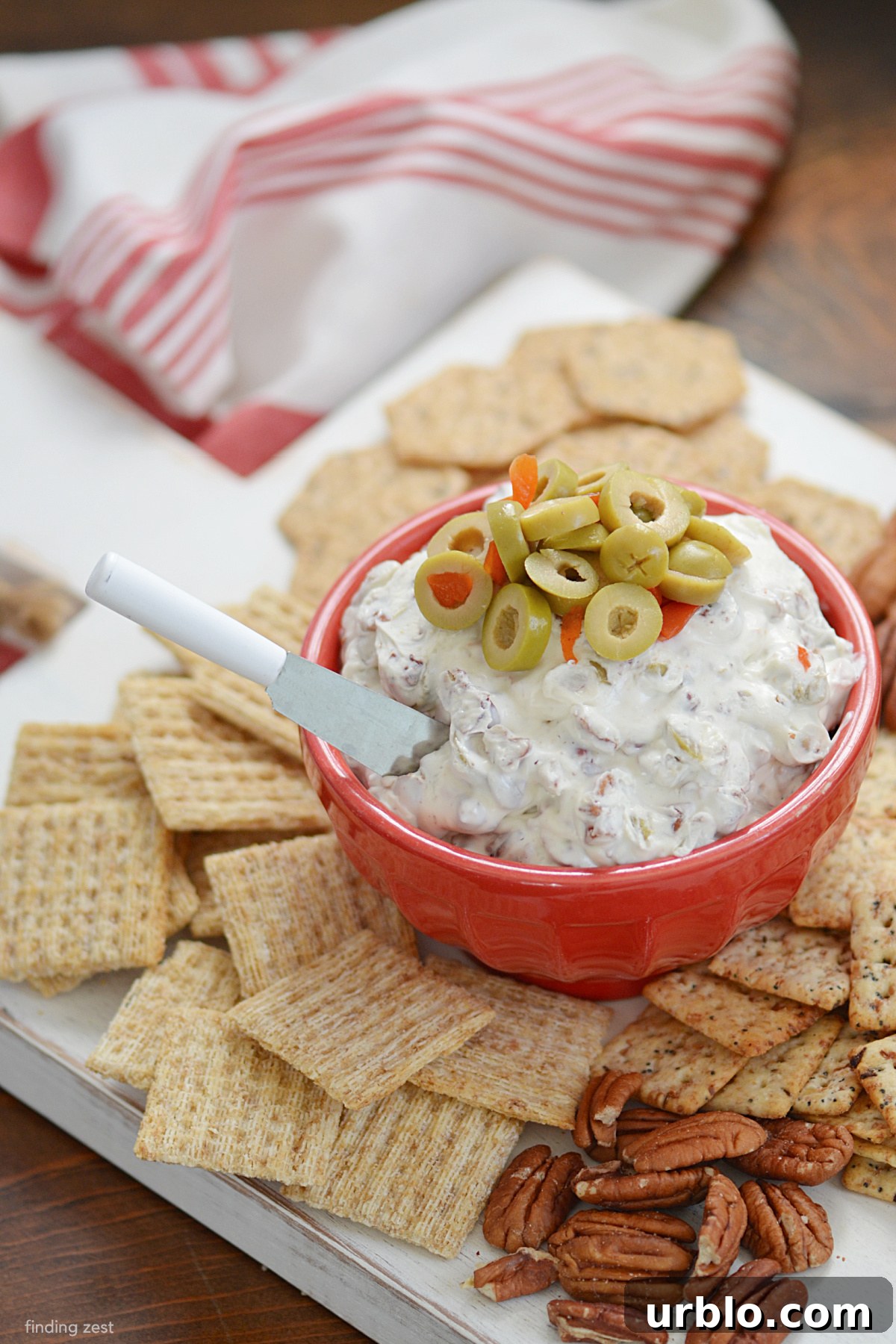 Olive Cream Cheese Spread is a super easy recipe with just four ingredients including cream cheese, sliced green olives, chopped pecans!