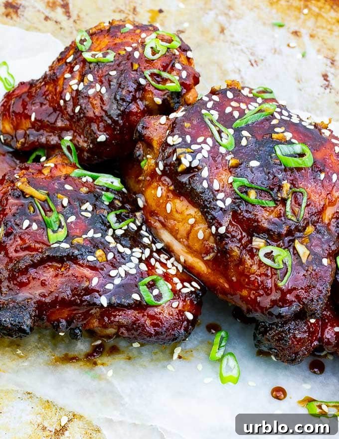 three pieces of Sticky Asian Grilled Chicken Thighs on white background