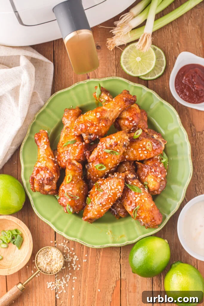 looking down onto honey sriracha wings on green plate