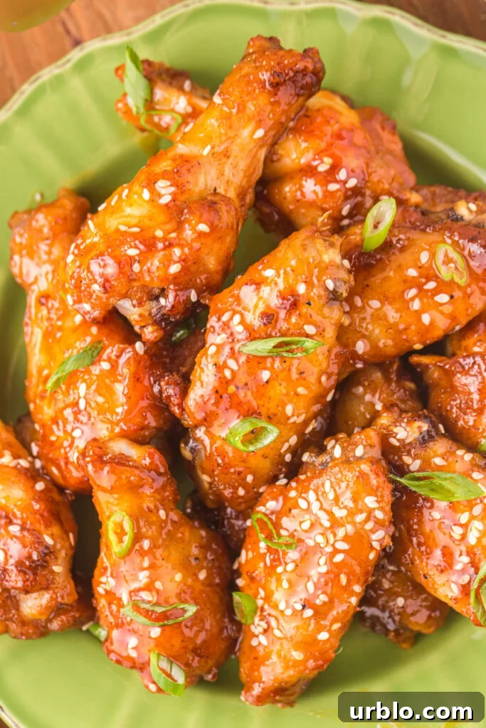 closeup of honey sriracha wings on green plate