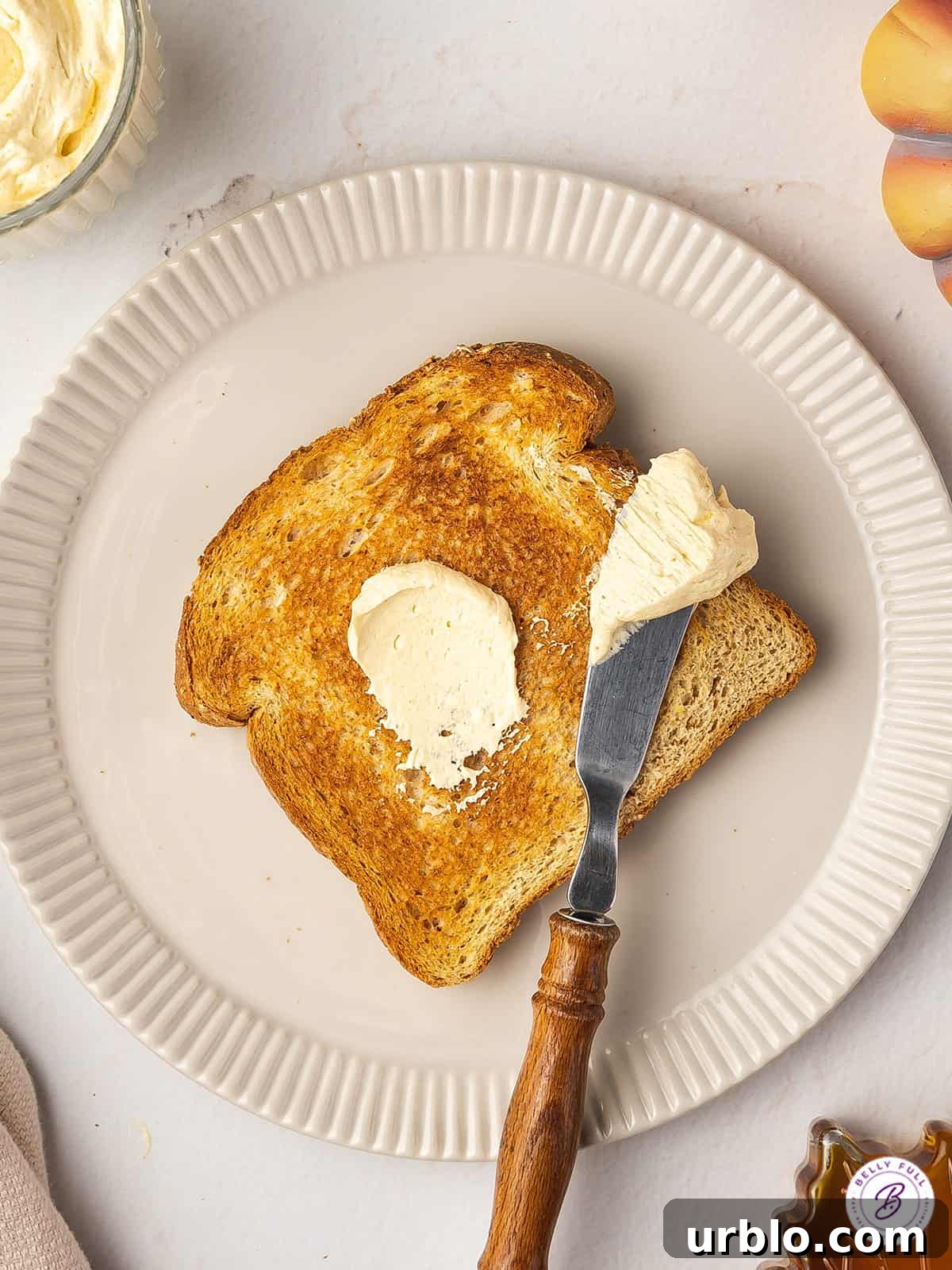 overhead swipe of butter on knife and toast