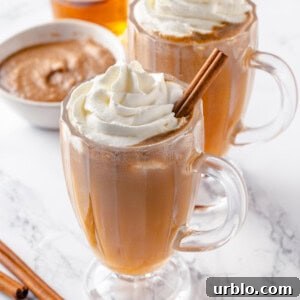 Two glass mugs of vegan hot buttered rum