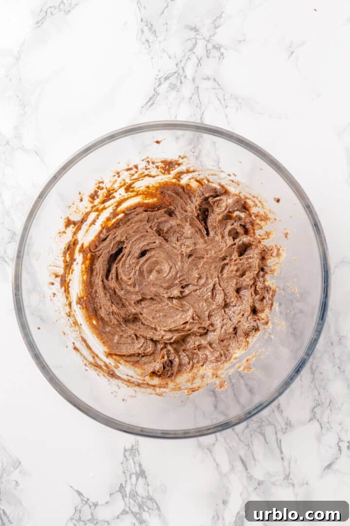 Overhead view of spiced butter in mixing bowl