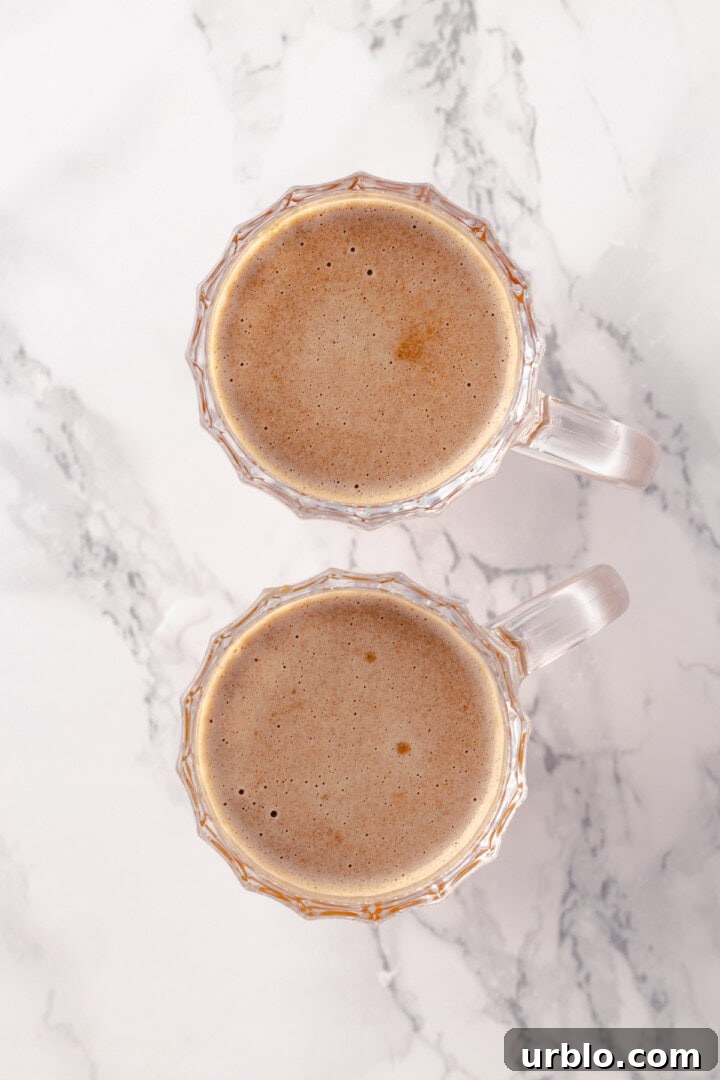 Overhead view of vegan hot buttered rum in mugs