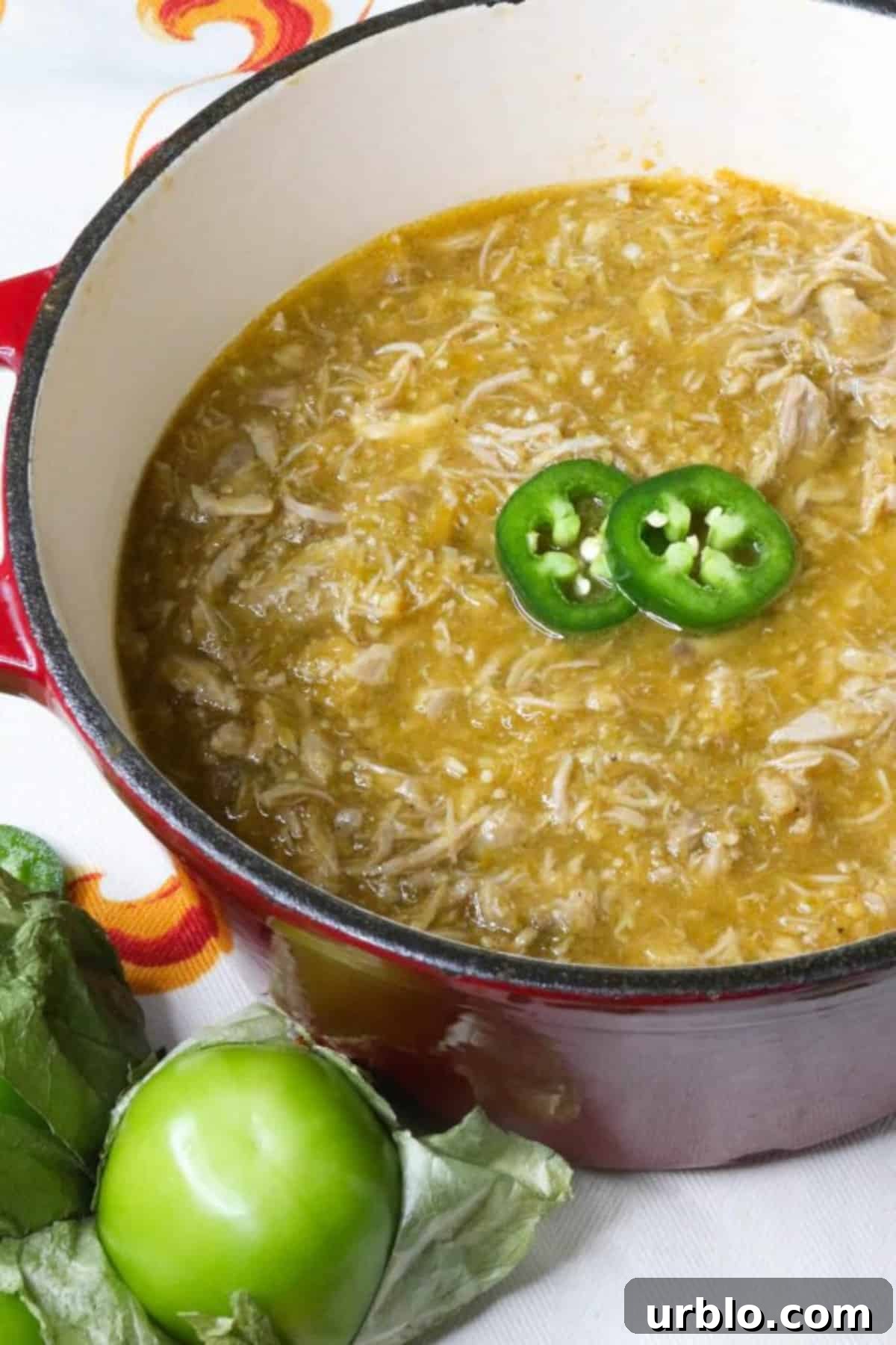 Salsa Verde Pulled Pork in a small, red Dutch oven