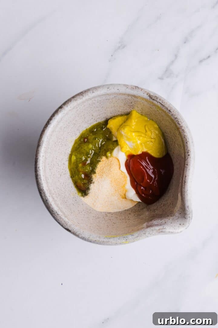 Ingredients for healthy big mac sauce in a small bowl, unmixed