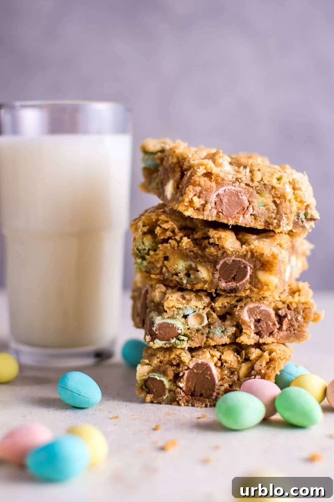 a stack of Mini Egg cookies with a glass of milk