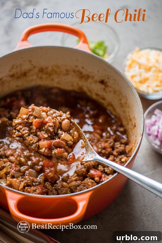 Dad's Famous Chunky Beef Chili Recipe with Beans | @bestrecipebox Beef Chili Recipe with Beans in cooking pot with spoon