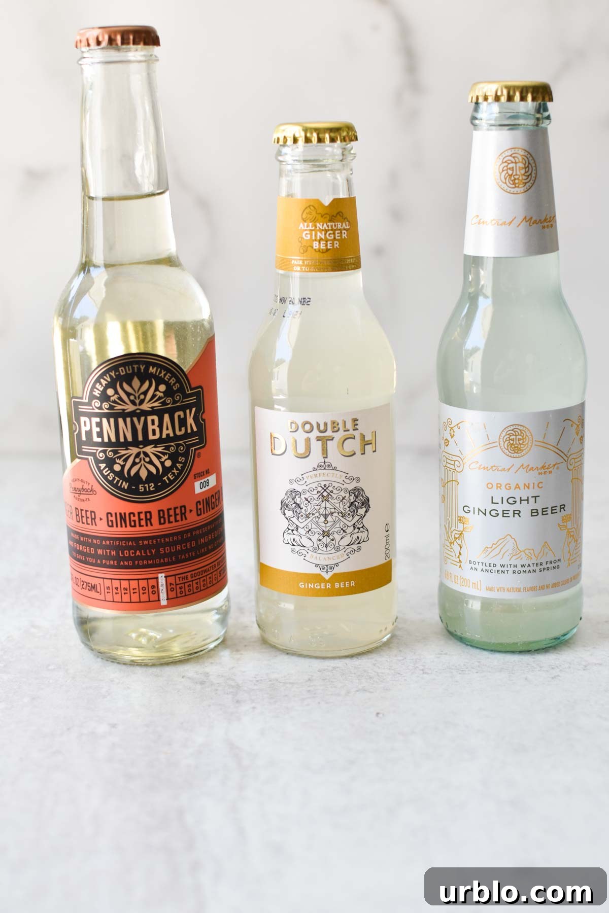 3 bottles of ginger beer on a white table