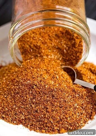 Ribs Spice Rub pouring out of a small glass jar