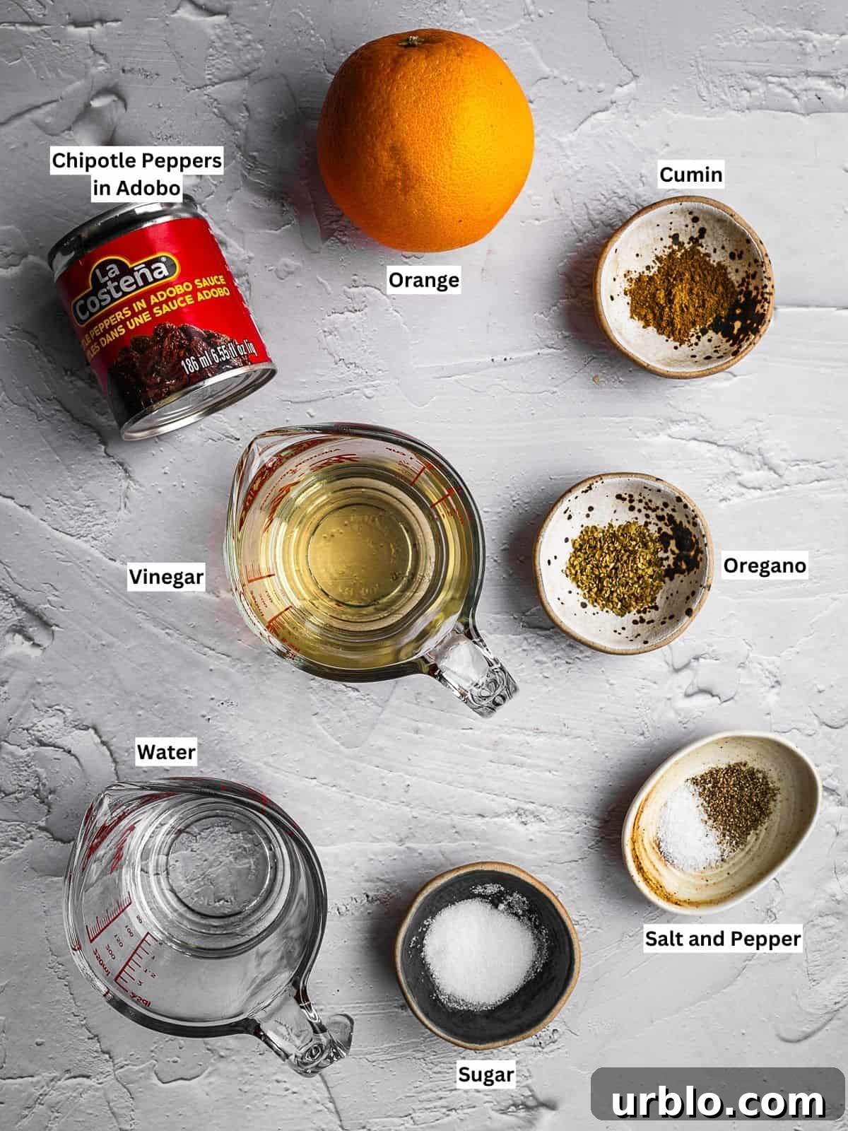 Chipotle hot sauce recipe ingredients with individual labels on a countertop.