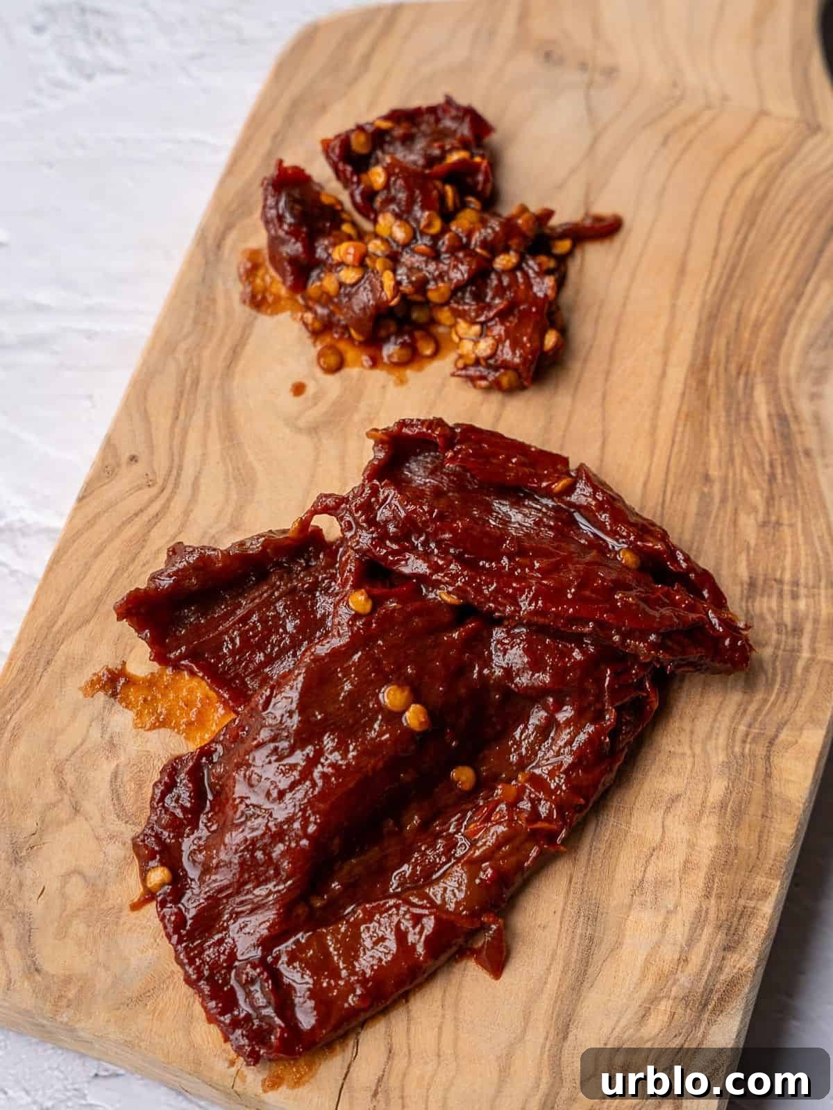 Chipotle chiles getting deseeded on a cutting board.