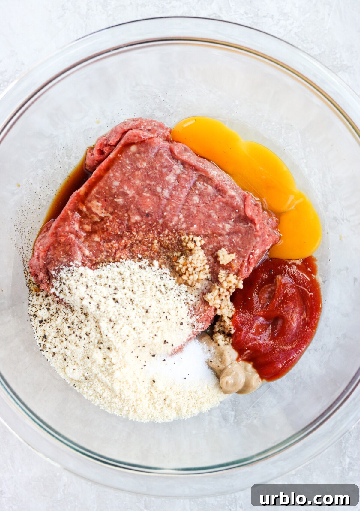 combining the ingredients in a glass mixing bowl