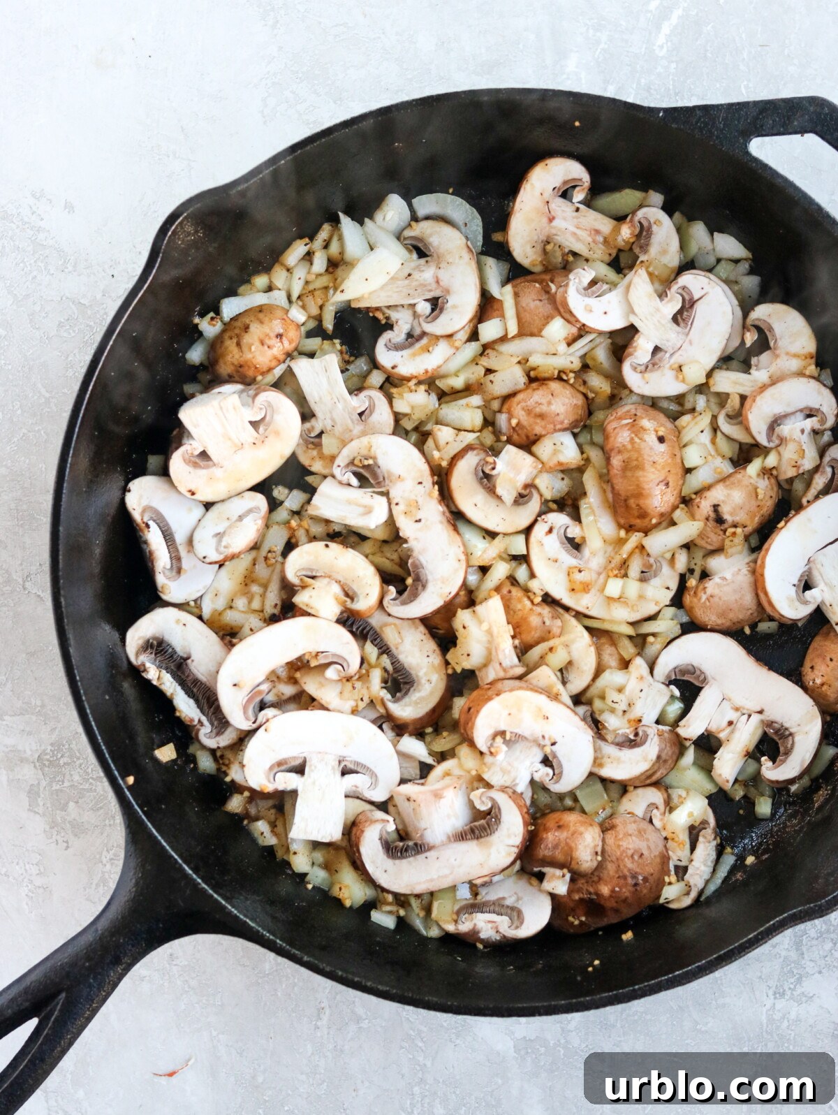 mushroom and onions sauteed in a skillet