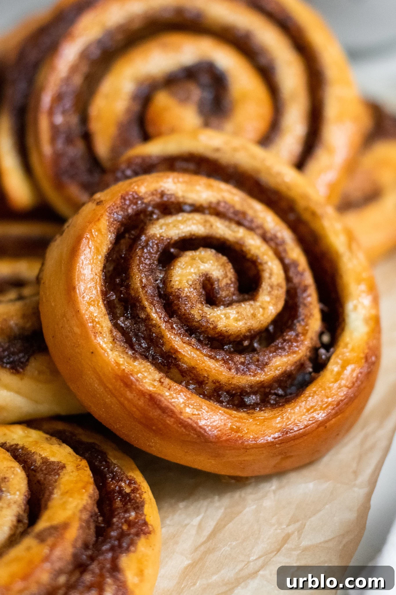Skandibaking Turns Two: Anniversary Recipes, Tips & Behind-the-Scenes 3 Cinnamon rolls in a pile.