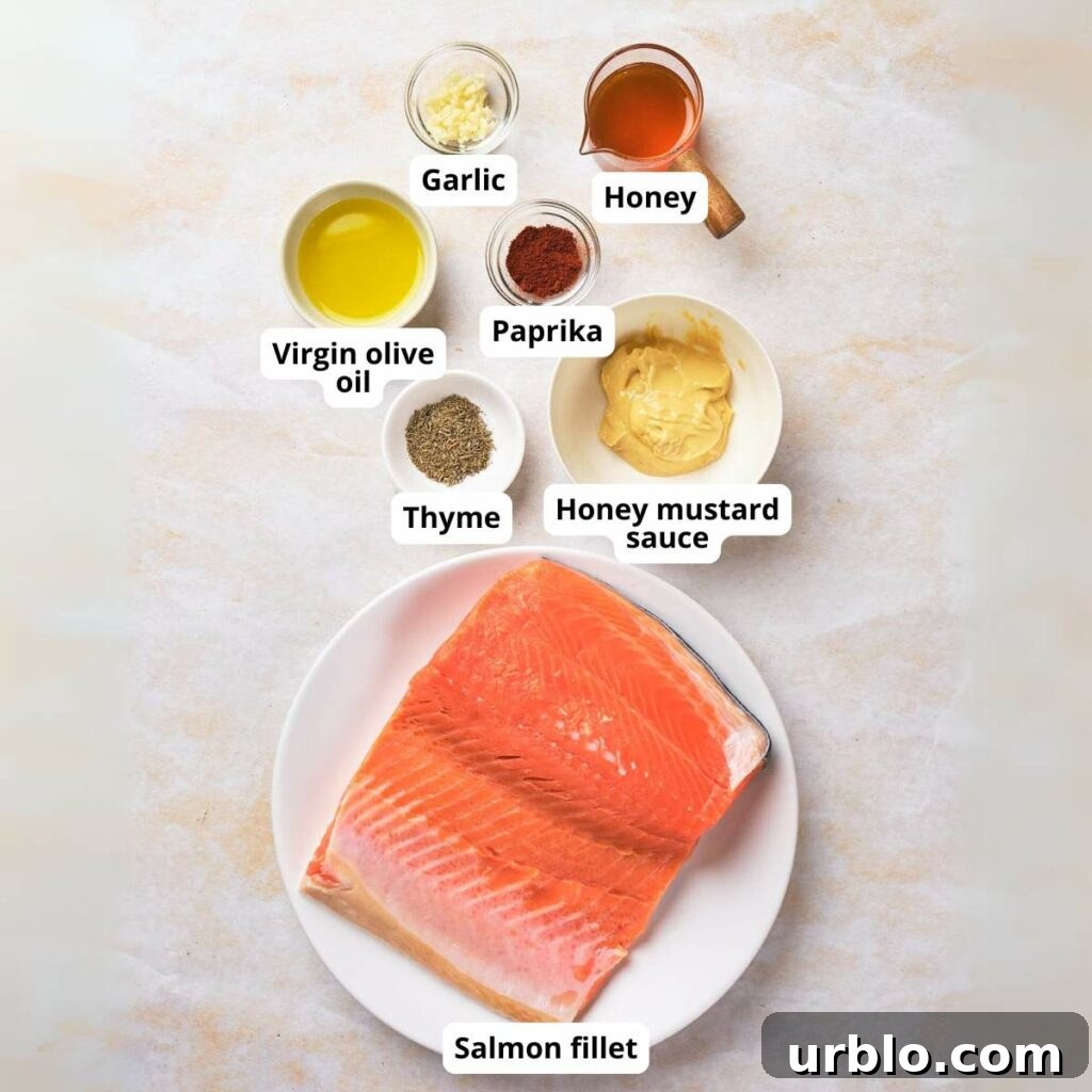 Ingredients for honey mustard glazed salmon on a surface, each labeled.