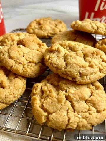 baked cookies on cookie rack with Tim Hortons containers in background