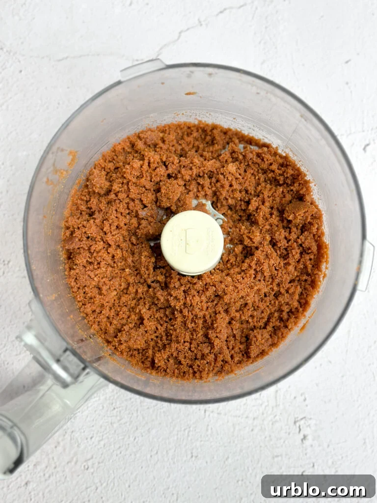 Biscoff cookie crumbs in food processor.