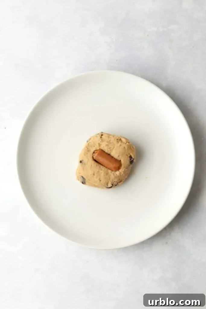 caramel being stuffed into cookie dough