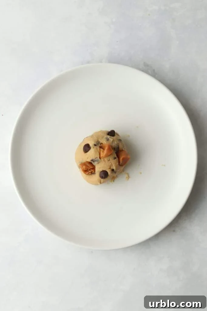 cookie dough ball topped with caramel and chocolate chips
