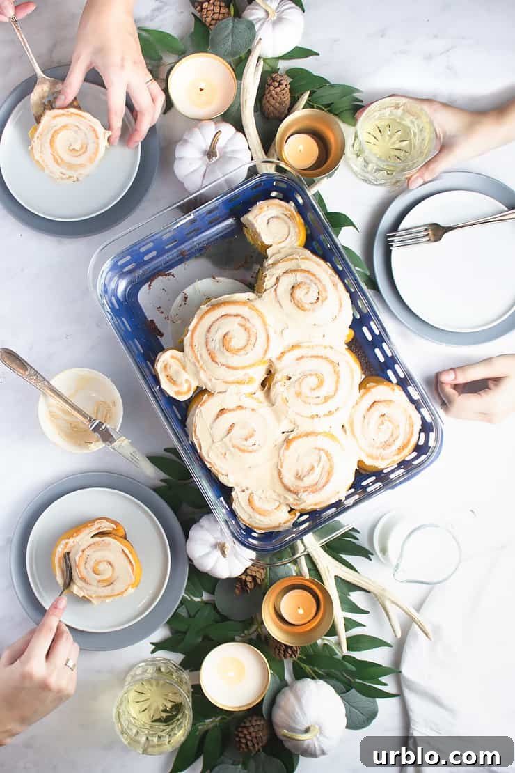 overhead photo of multiple hands around a plate of cinnamon rolls