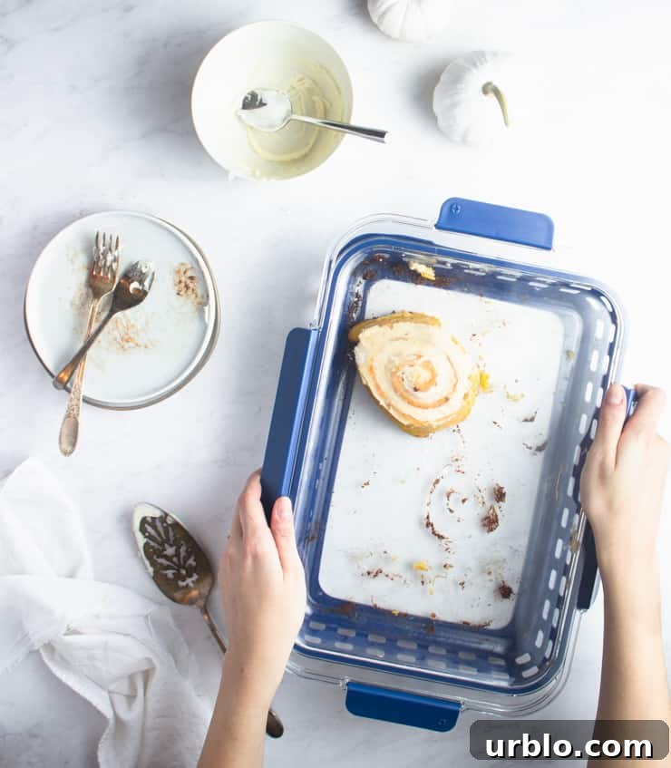 packing up leftover cinnamon rolls with dirty dishes