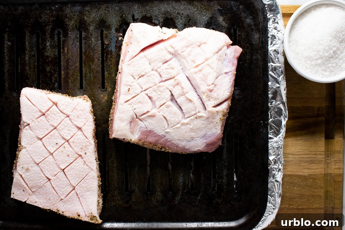 Crispy Salt-Crusted Pork Belly Recipe with Tender Juicy Meat 5 pork belly scored on a broiler pan.