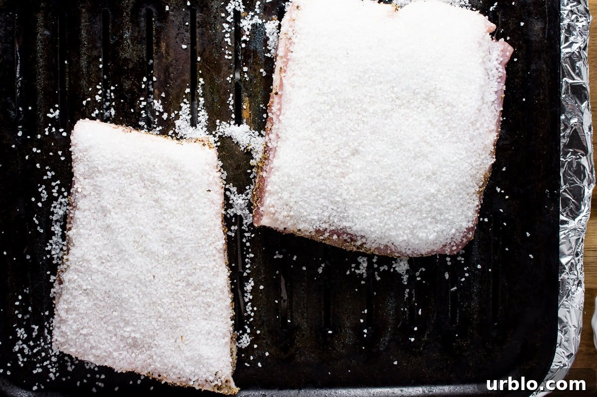 Crispy Salt-Crusted Pork Belly Recipe with Tender Juicy Meat 6 pork belly covered in salt.