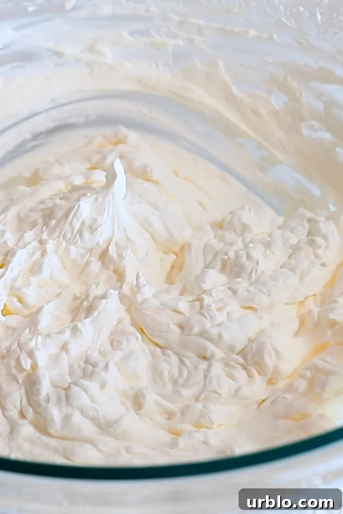 Silky Lemon Mousse Recipe with Fresh Citrus Zest 13 stiff whipped cream in a bowl