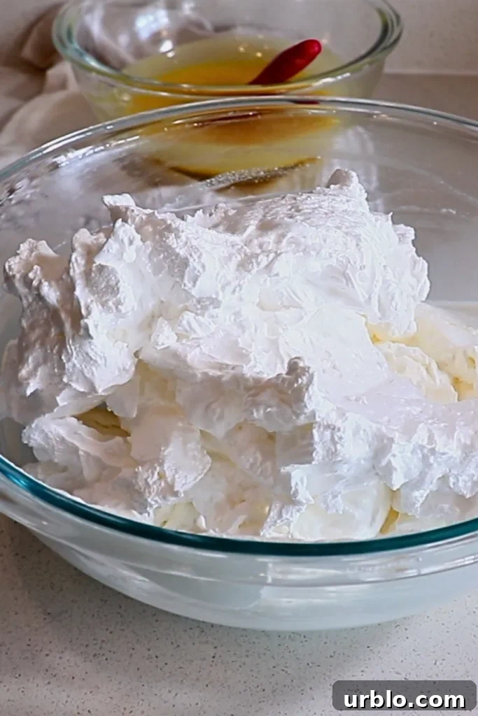Silky Lemon Mousse Recipe with Fresh Citrus Zest 16 the combined Italian meringue and whipped cream in a bowl