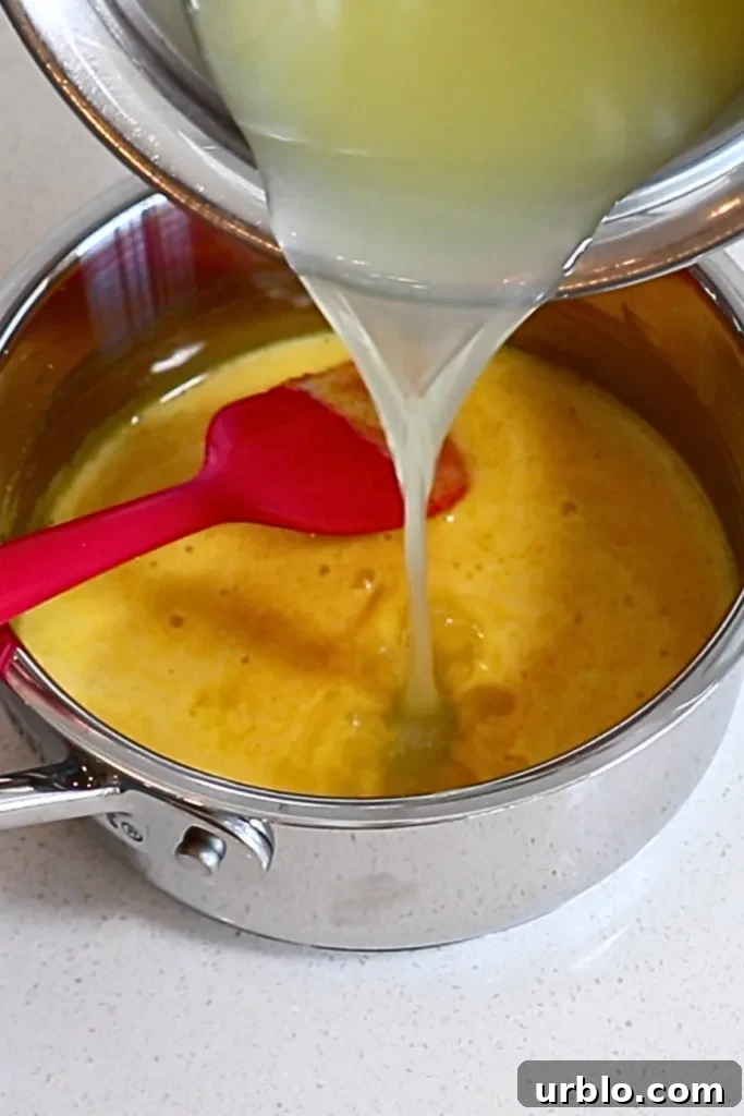 Silky Lemon Mousse Recipe with Fresh Citrus Zest 8 adding lemon juice to the yolk mixture
